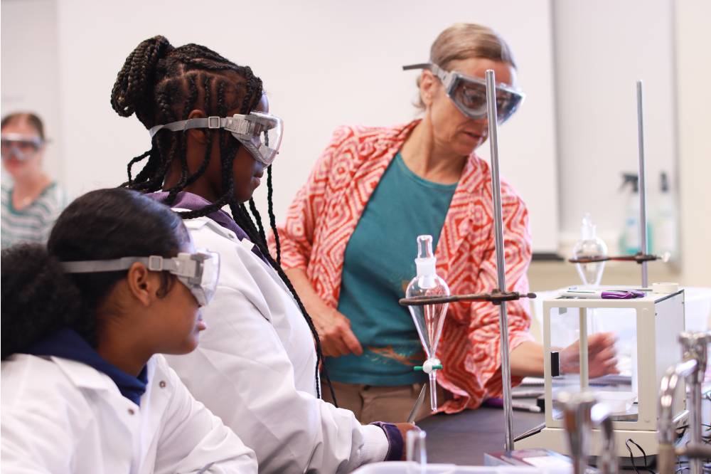 Image 1 of 13 Camp facilitator with students